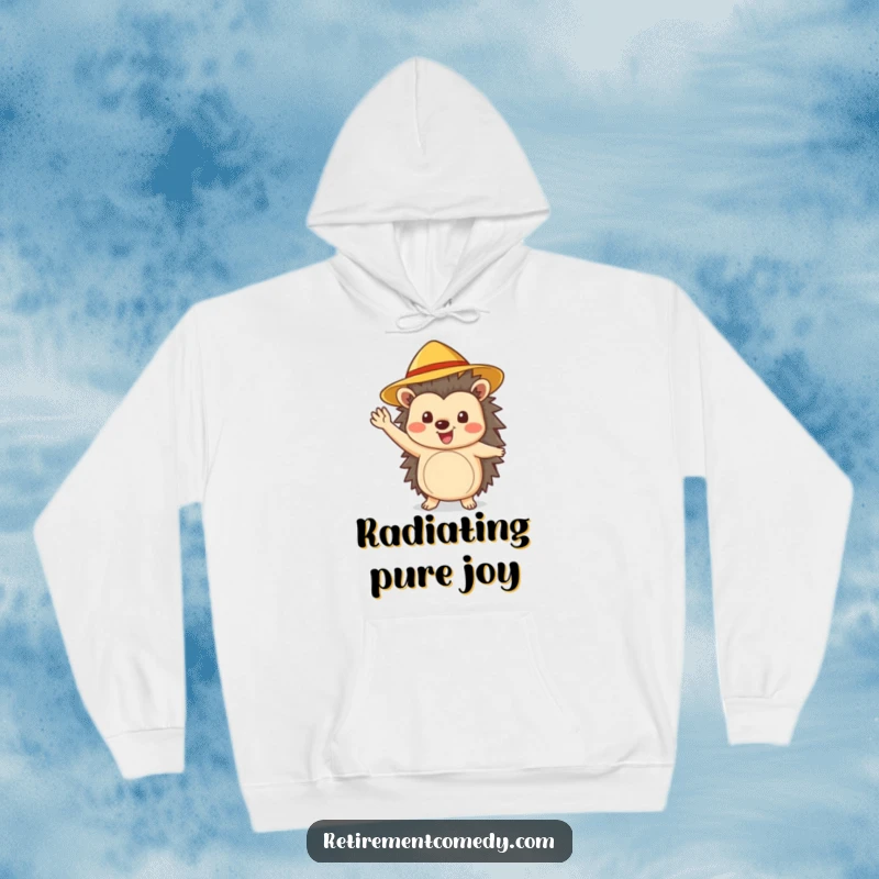 Funny cheerful hedgehog wearing a sun hat waves enthusiastically on this cozy hoodie, perfect for outdoor excursions.